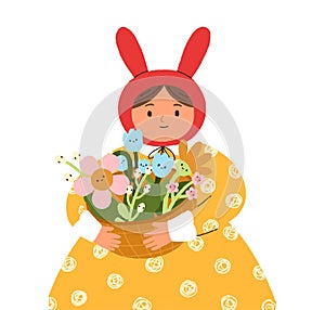 Girl in bunny ears, holding spring flowers in basket. Cute funny child, adorable kid rabbit with Easter holiday gift
