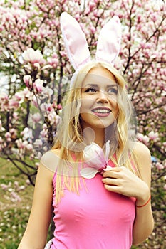 Girl in bunny ears with magnolia branch