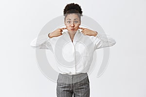 Girl burst from pressure like bubble. Sulking good-looking playful female with afro hairstyle in suit, holding breat and