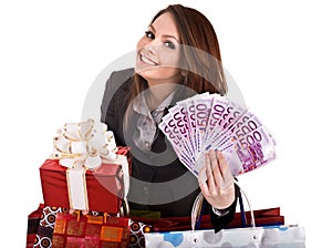 Girl in business suit with money, gift box, bag.