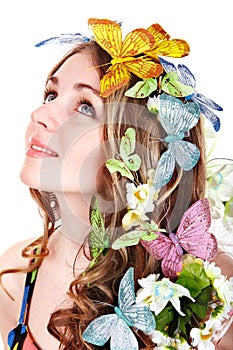 Girl with butterfly and flower on head.