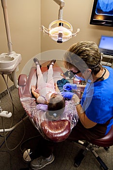 Girl With Butterfly Wings Being Worked On By Female Dentist