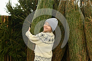 A girl buying a Christmas tree in a shop