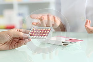 Girl buying contraceptive pills in a pharmacy