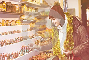 Girl buying figures for creating Christmas