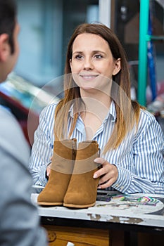 girl buys shoes at counter