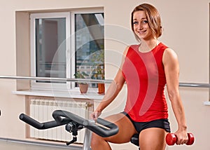 Girl bycicle cycling in gym