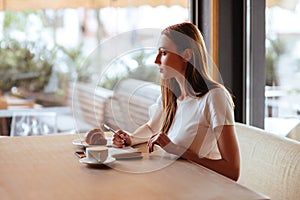 Girl in cafe with capuccino