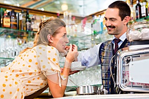 Girl in cafe or coffee bar flirting with barista