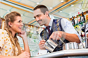 Girl in cafe or coffee bar flirting with barista