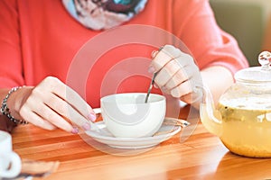Girl in a cafe with a cup of tea and drinking hot herbal tea. fr