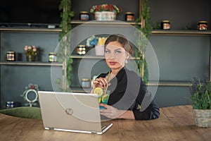 Girl in caffe typing on laptop and relaxing