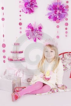 Girl with cake at pink decoration birthday party