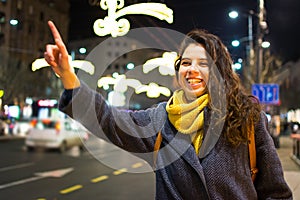 Girl calling taxi in urban environment