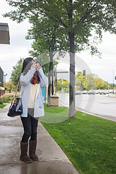 Girl with camer on public side walk