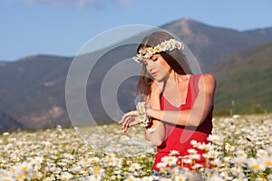 Girl on camomile field