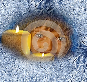 Girl with candles looking through a frosted window