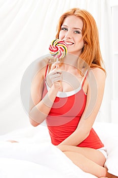 Girl with candy in bedroom