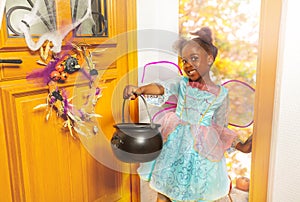 Girl with candy bucket in Halloween costume