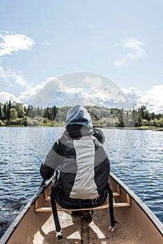 Girl canoeing with Canoe on the lake of two rivers in the algonquin national park in Ontario Canada on sunny cloudy day