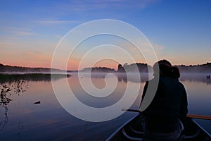 Girl Canoing at Sunrise