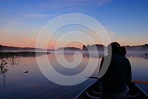 Girl Canoing at Sunrise photo