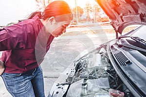 Girl car engine overheat brake down standing looking at the engine open car hood