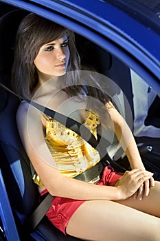 Girl in car fastened by seat belt
