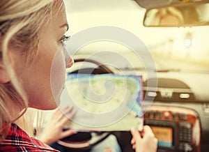 Girl in car with roads map