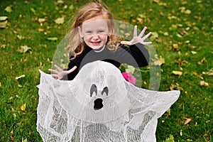 Girl in carnival costume on halloween with toy ghost