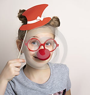 Girl in carnival mask with clown nose, hat and eyeglasses