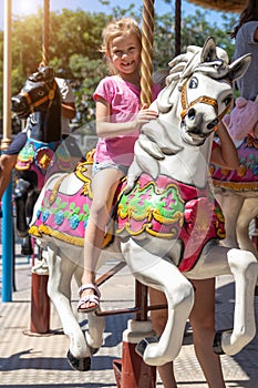 Girl on a carousel in an amusement park