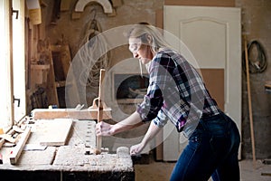 Girl carpenter working in workshop