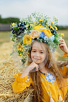 Girl carries fluttering blue and yellow flag of Ukraine in field