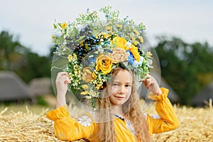 Girl carries fluttering blue and yellow flag of Ukraine in field