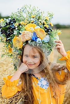 Girl carries fluttering blue and yellow flag of Ukraine in field