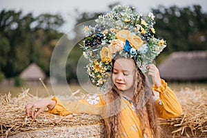 Girl carries fluttering blue and yellow flag of Ukraine in field