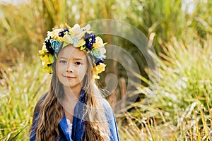 Girl carries fluttering blue and yellow flag of Ukraine in field