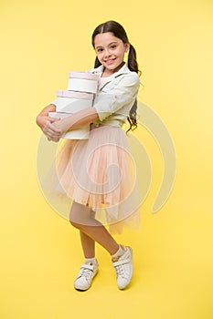Girl carries pile boxes. Create shopping list to save money. Back to school season great time to teach budgeting basics