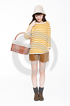 Girl carrying a basket in the room