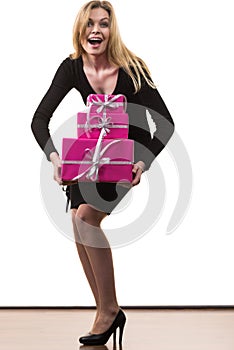 Girl carrying many pink gift boxes