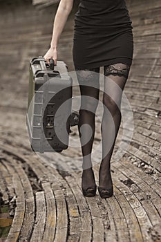 A girl carrying a motorcycle pannier