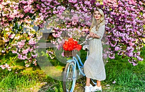 Girl casual dress retro cruiser bicycle sakura tree. Spring holidays. Tourism concept. Transportation and travel. Sakura