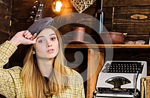 Girl in casual outfit with kepi in wooden vintage interior. Girl tomboy spend time in house of gamekeeper. Lady on calm