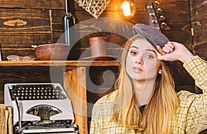 Girl in casual outfit with kepi in wooden vintage interior. Girl tomboy spend time in house of gamekeeper. Lady on calm