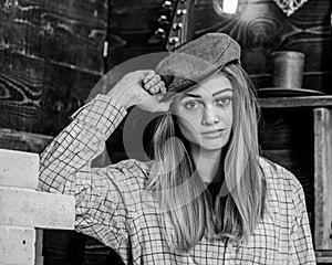 Girl in casual outfit with kepi in wooden vintage interior. Girl tomboy spend time in house of gamekeeper. Tomboy