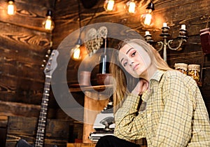 Girl in casual outfit in wooden vintage interior. Girl tomboy spend time in house of gamekeeper. Lady on dreamy face in