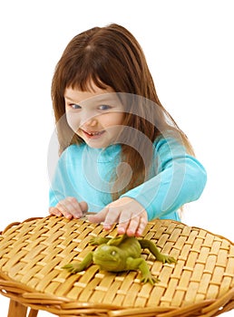 Girl cautiously stroking a toy lizard