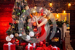 Girl celebrate new year decorating christmas tree. Sexy girl red dress celebrate merry christmas. Christmas celebration