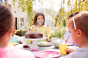 Girl Celebrating Birthday With Friends Having Party In Garden At Home